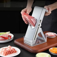 Artefacto cortador de verduras con agitación manual, triturador y rebanador